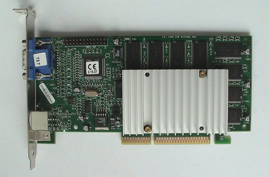 3dfx Voodoo3 3000 graphics card with passive heatsink, VGA and S-Video bracket, photographed against a plain light background