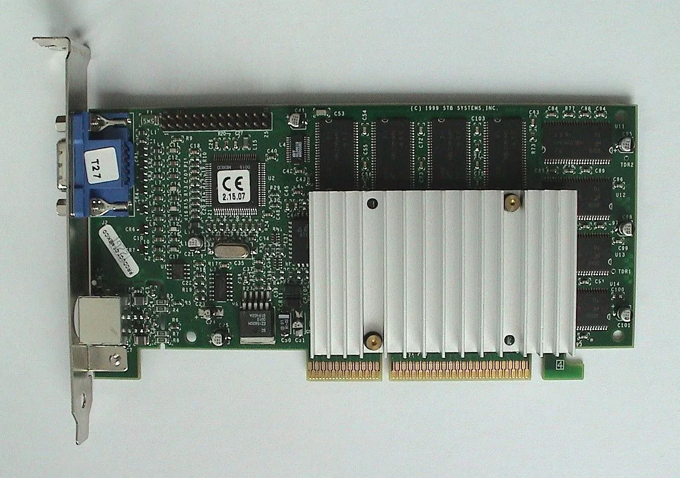 3dfx Voodoo3 3000 graphics card with passive heatsink, VGA and S-Video bracket, photographed against a plain light background