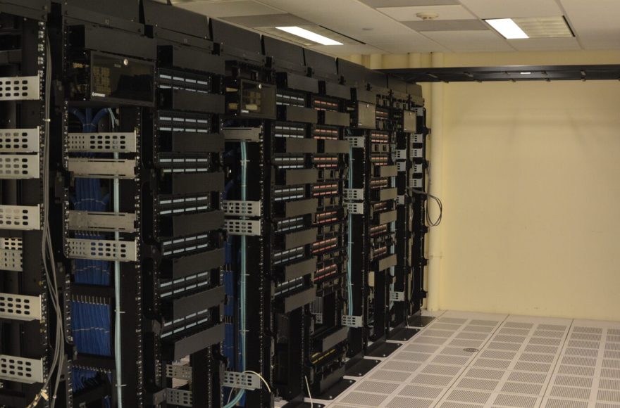 Server racks in a data center, representative of AI infrastructure