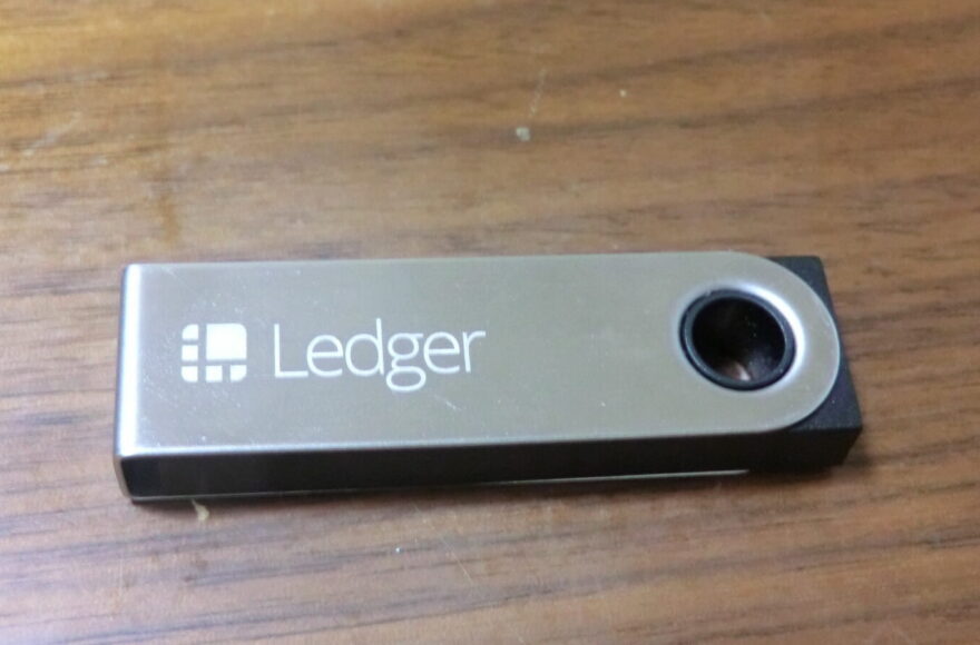 Illustrative Ledger Nano S hardware wallet on a wood surface, not evidence of the device in Ledger's investigation.